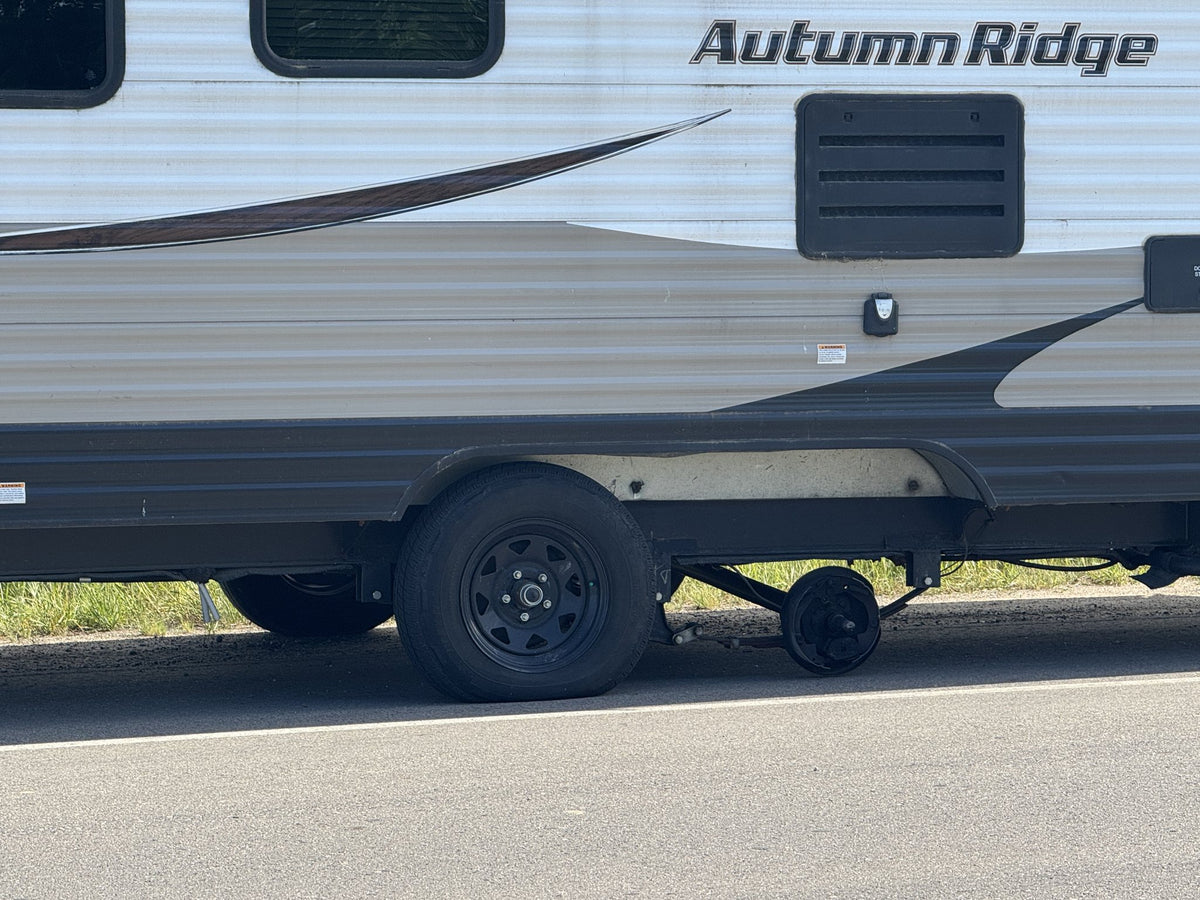 Travel trailer tandem axle with the rear wheel and hub gone, brake assembly exposed