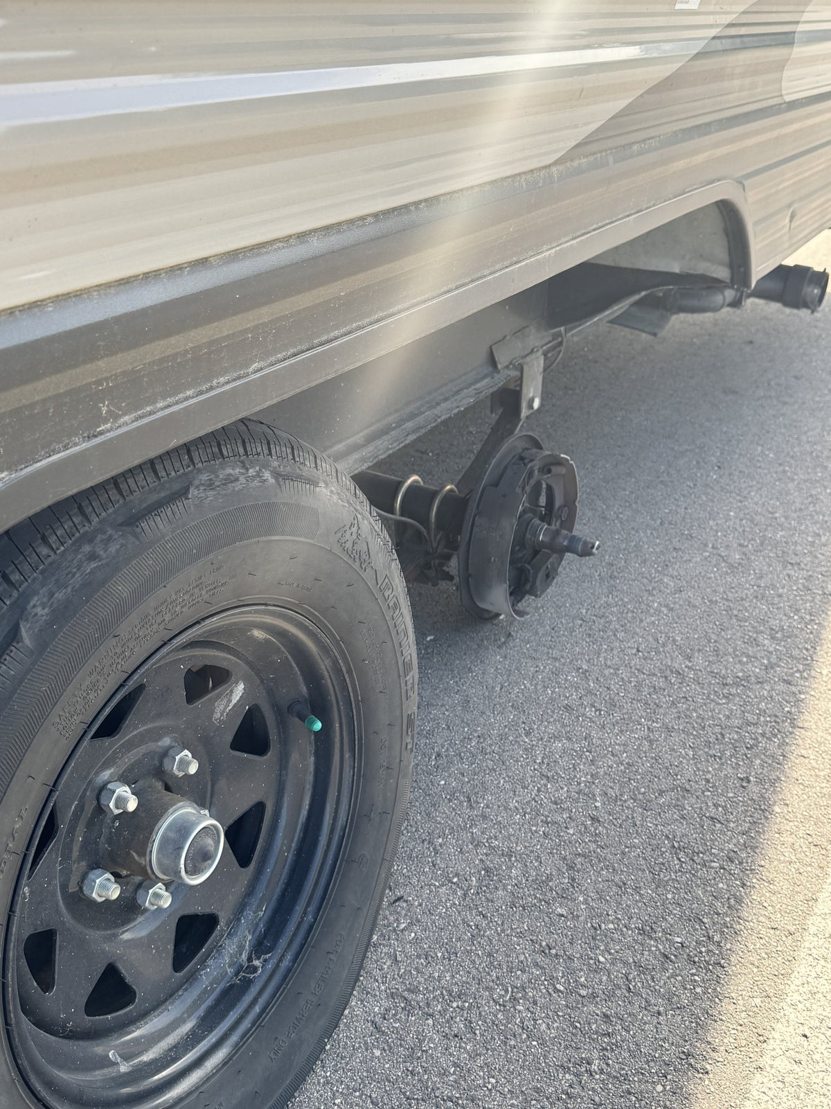 Close-up of the bare spindle and brake backing plate where the wheel used to be