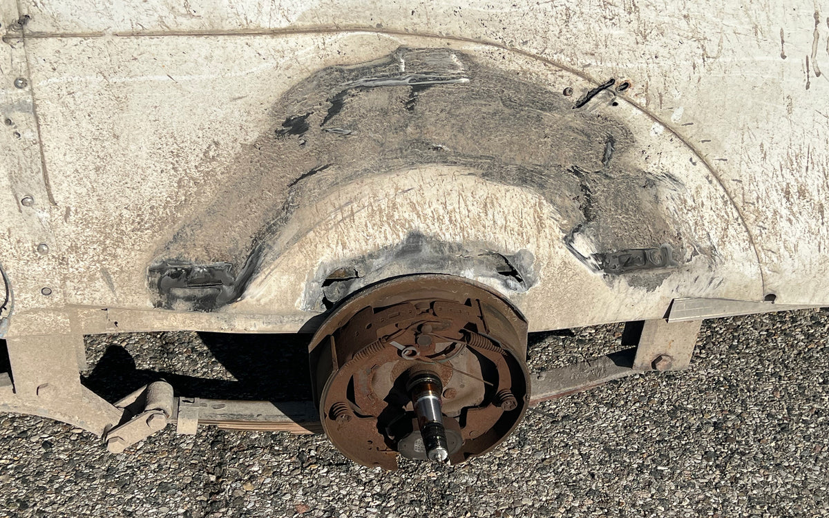 Trailer wheel well and brake assembly after a bearing failure took the wheel off